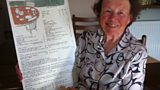 Joyce Molyneux with the original menu from The Hole in the Wall restaurant