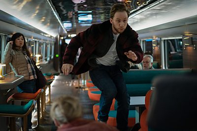 Joe Roag (JOE COLE) & Supporting Artists in episode 1 of Nightsleeper (Credit: BBC/Euston Films/Mark Mainz)