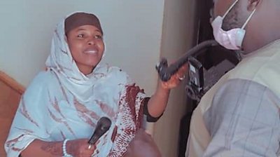 Journalist Amina Ahmed interviewing people