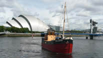 Vital Spark puffer with Clyde Auditorium in background